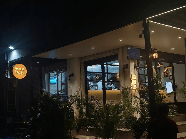 Traditional brass lamps and decor inside Madras Mandir Cafe