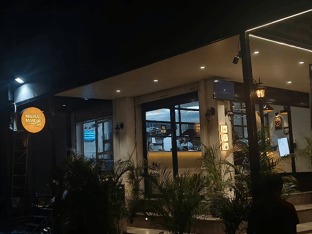 Traditional brass lamps and decor inside Madras Mandir Cafe